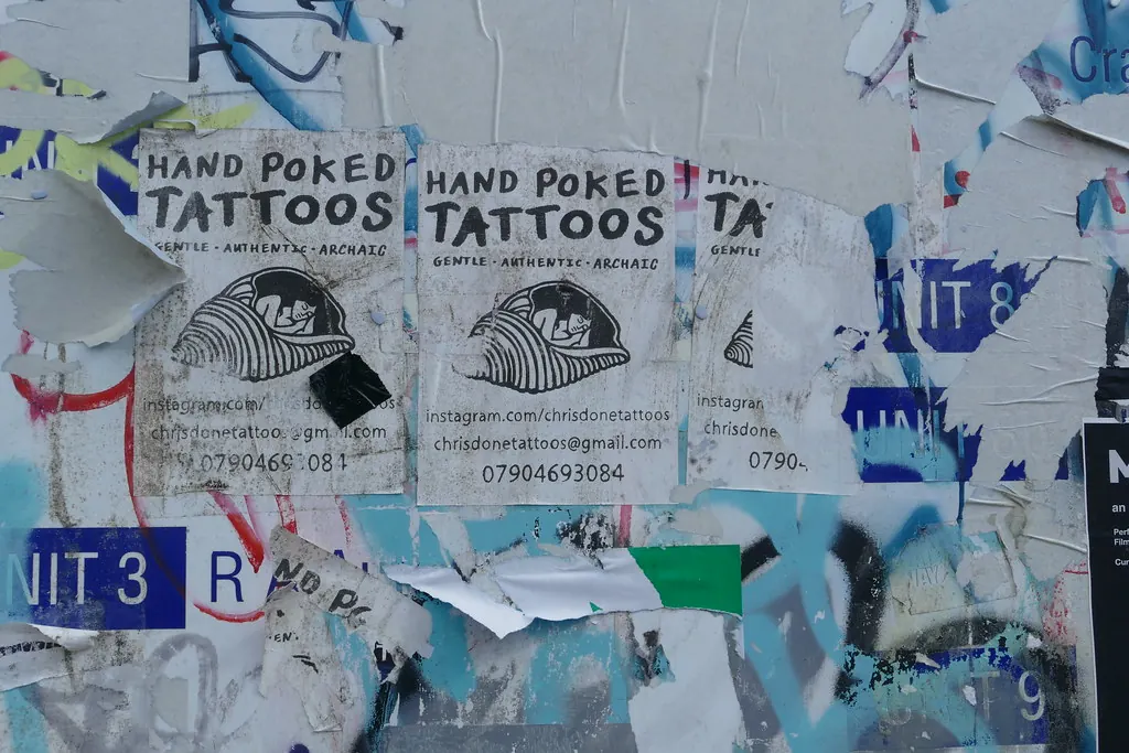 Street posters advertising hand-poked tattoos