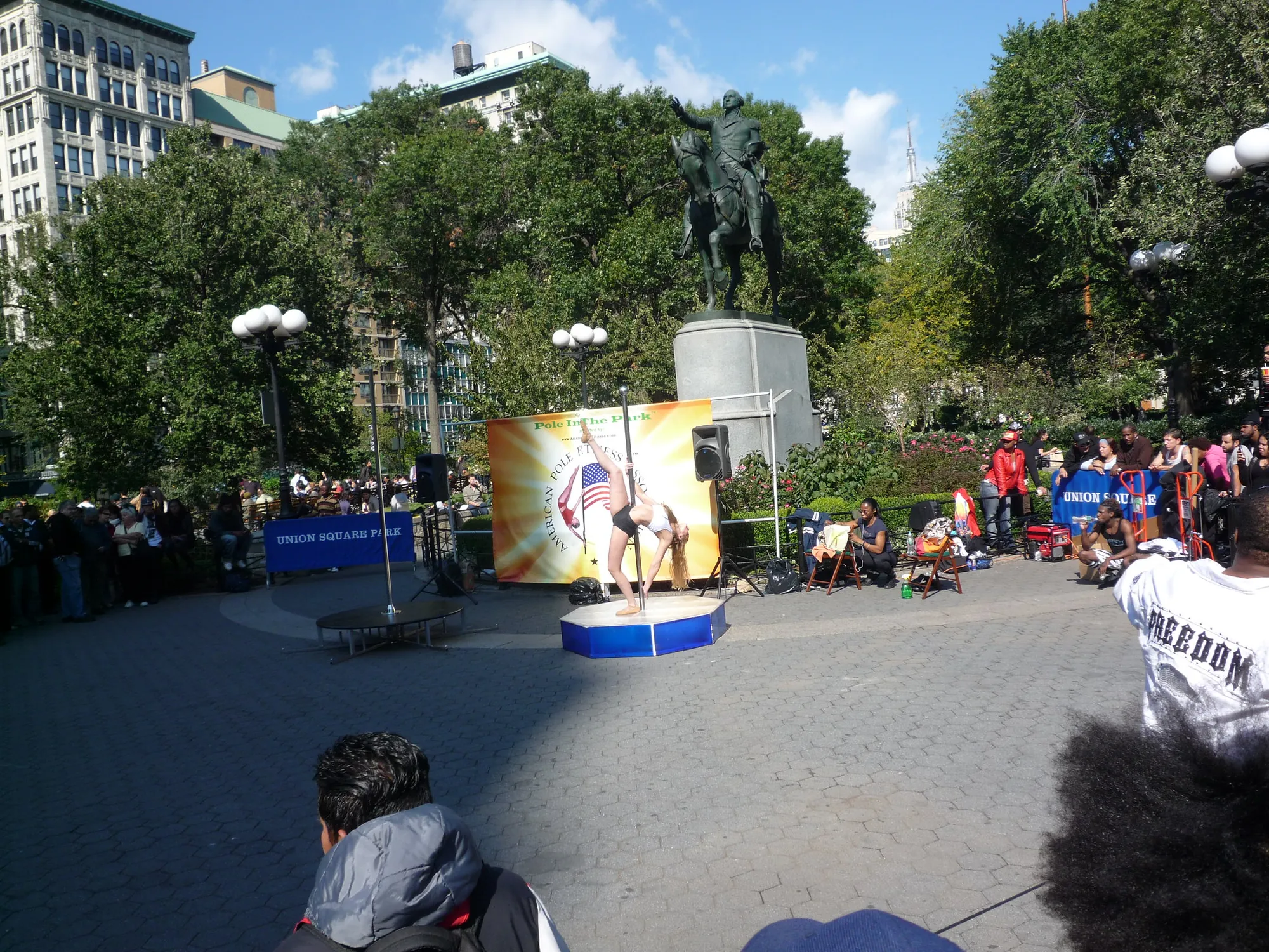 Pole fitness demonstration on a stage in Union Square, New York